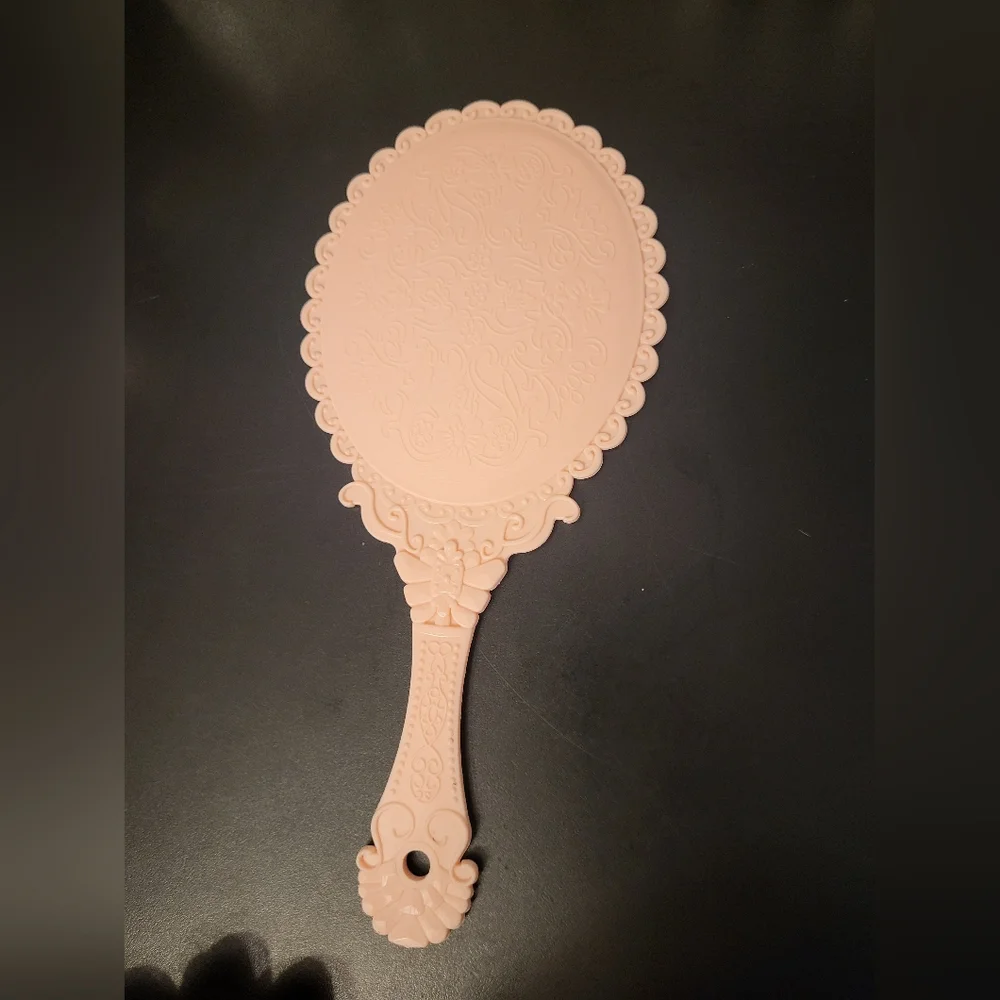 Pink plastic fantasy hand mirror